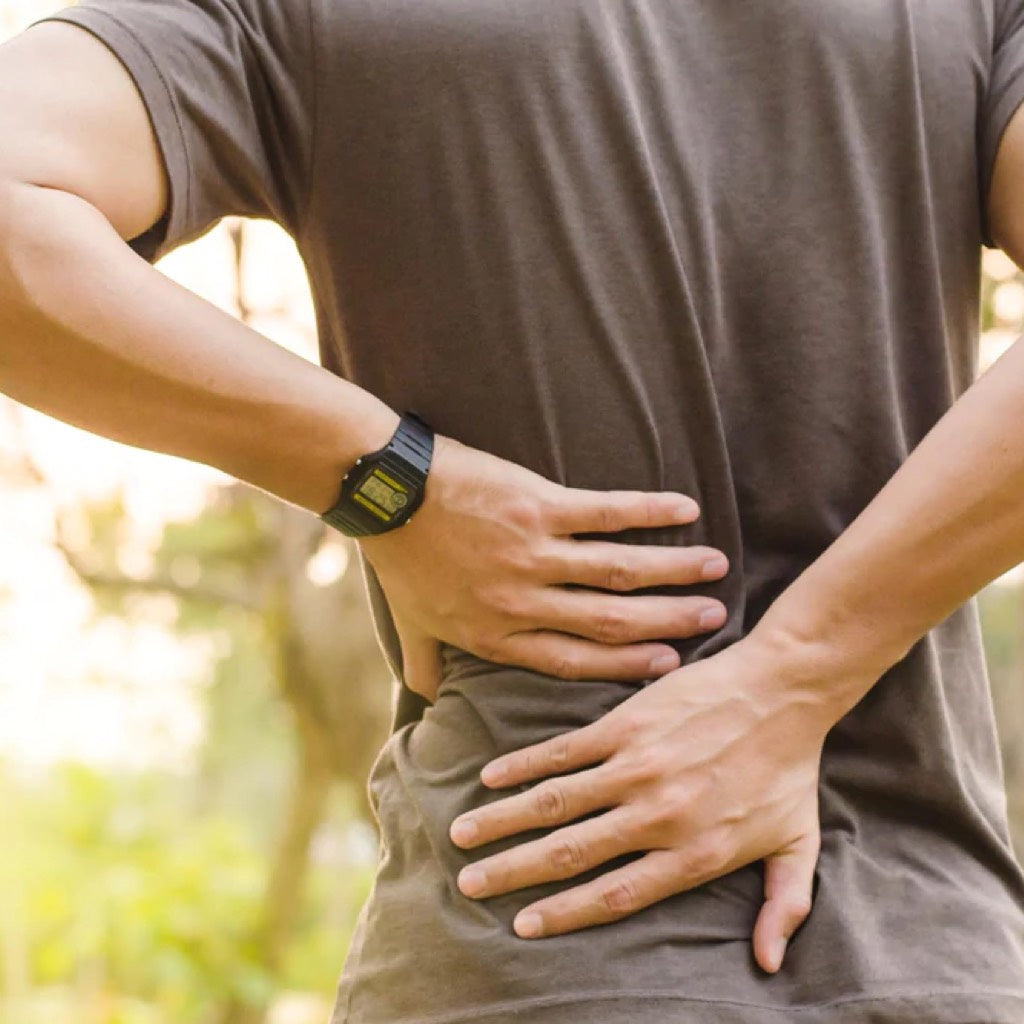 Person holding onto their side with 2 hands